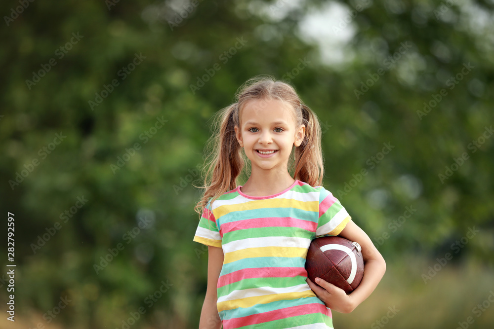 Portrait of cute little girl with rugby ball outdoors Stock Photo | Adobe  Stock