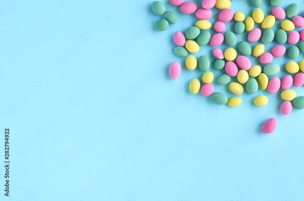 Colored sweets, peanut covered with glaze on blue background composition. Colored sweets, peanut covered with glaze on blue background composition.
