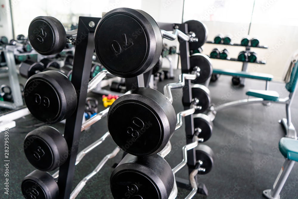 Sports equipment in gym Barbells of different weight on rack Sports equipment in gym Barbells of different weight on rack