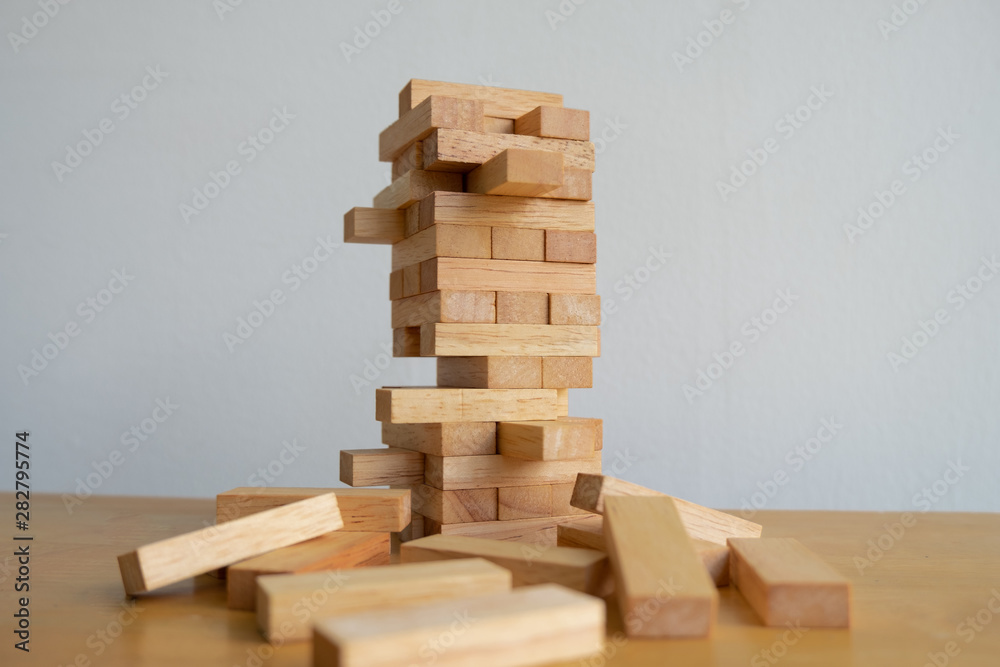 Wood block tower with architecture model, Concept Risk of management and strategy plan, growth business success process and team work Wood block tower with architecture model, Concept Risk of management and strategy plan, growth business success process and team work