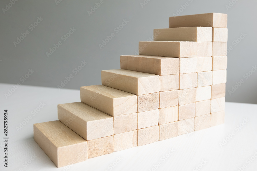 Wood block tower with architecture model, Concept Risk of management and strategy plan, growth business success process and team work Wood block tower with architecture model, Concept Risk of management and strategy plan, growth business success process and team work