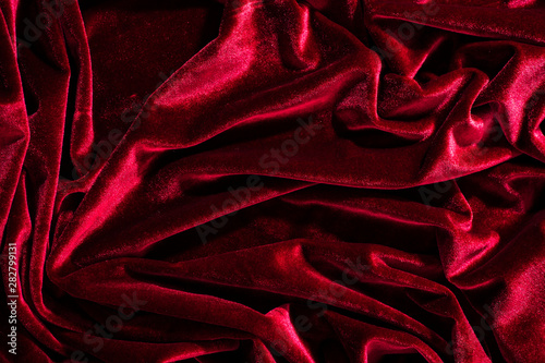 Background image of crumpled fabric. Red velvet