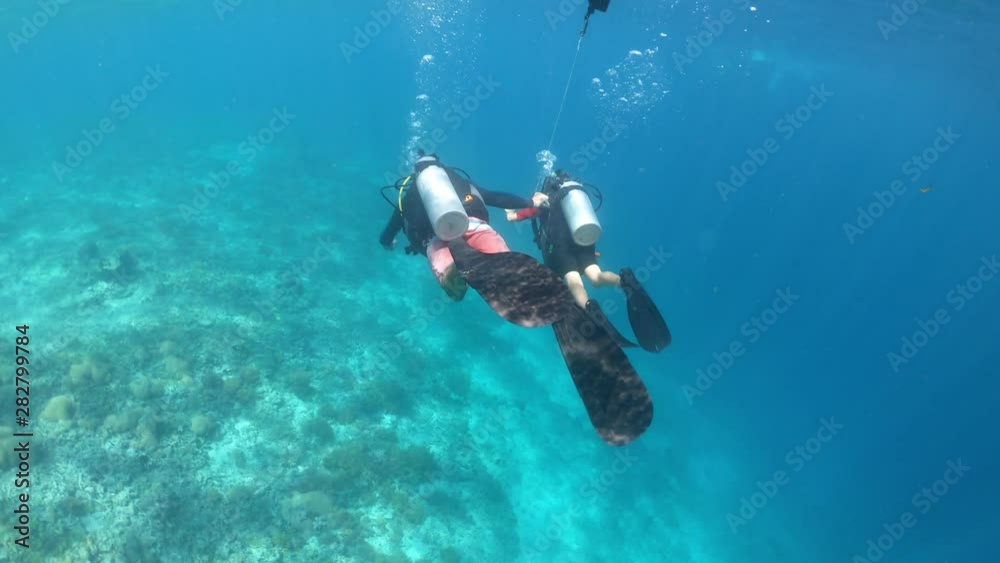 Child girl doing a scuba diving course in Gili Islands a world renown diving near Bali and Lombok Islands Indonesia. Child girl doing a scuba diving course in Gili Islands a world renown diving near Bali and Lombok Islands Indonesia.