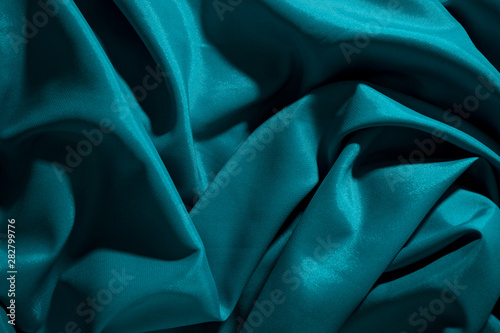 Background image of crumpled fabric. Blue silk