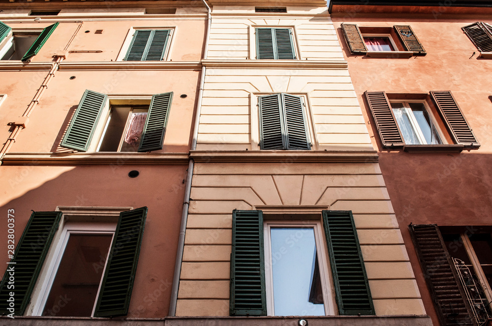 Pattern facade of building with windows and shutters italian architecture Tuscany Italy