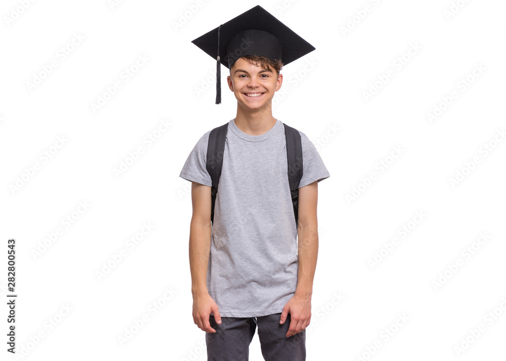 Young graduate student - Happy teen boy in bachelor hat with backpack, isolated on white background. Smiling child In Corner-Cap looking at camera. Teenager guy in Graduation Cap Back to school. Young graduate student - Happy teen boy in bachelor hat with backpack, isolated on white background. Smiling child In Corner-Cap looking at camera. Teenager guy in Graduation Cap Back to school.