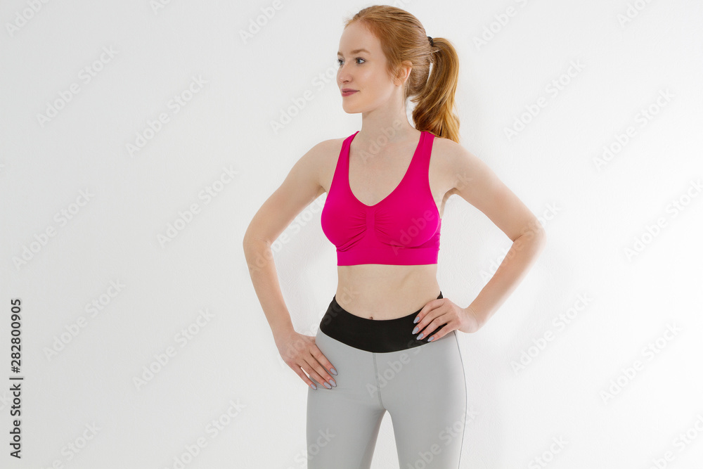 Young sporty girl in sport wear clothes isolated on white background. Happy weight loss woman body concept. Athletic body and adult activity. Copy space Young sporty girl in sport wear clothes isolated on white background. Happy weight loss woman body concept. Athletic body and adult activity. Copy space