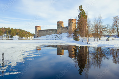 March landscape with the old  Olavinlinna fortress. Savonlinna, Finland photo