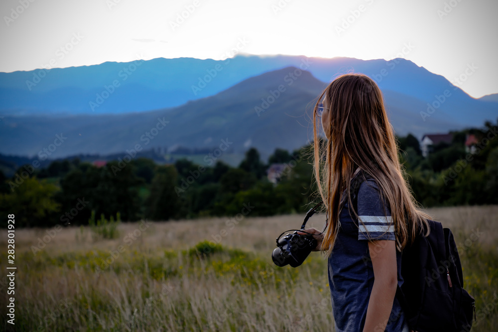 young woman photographer in the mountains