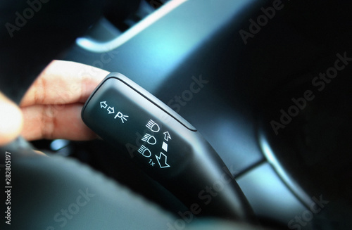 Fotografia Close up on car headlight control lever used to select vehicle headlight mode