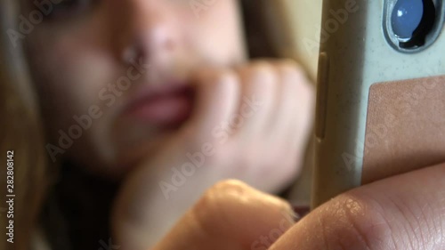 Ultra HD. Beautiful young caucasian girl using her mobile in a cafe, typing on her phone through social networks. Social media. Always connected. The internet concept. Every day.