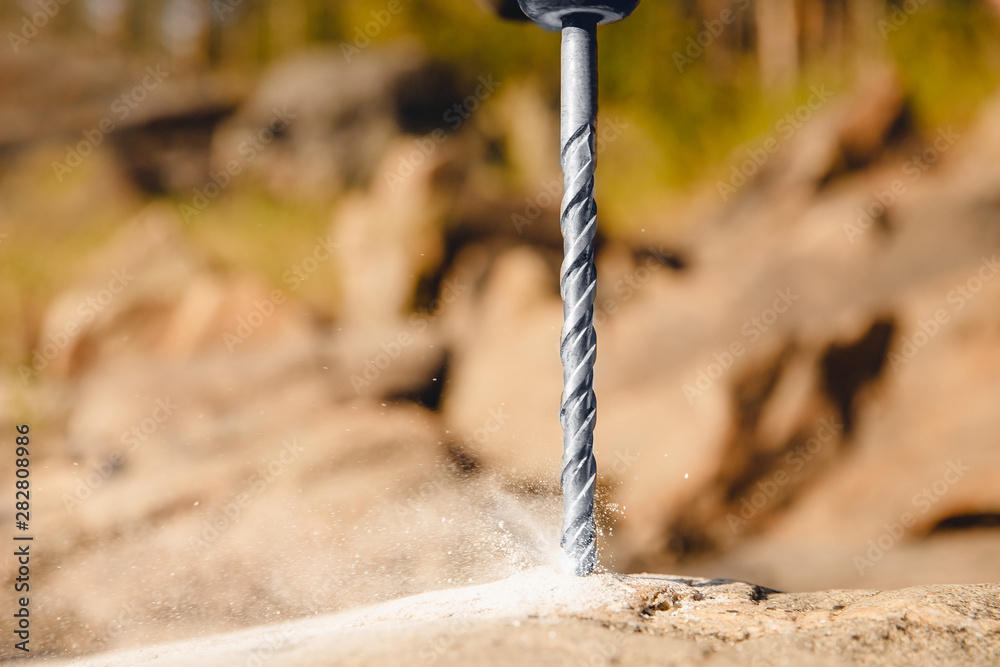 Drill for holes in stone and brick walls, professional tool ภาพถ่าย