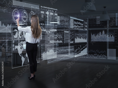 Back view of businesswoman working with virtual panel