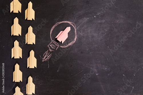 Business planning. Strategy. Challenge, improvment and progress concept. Red rocket leader on black background
