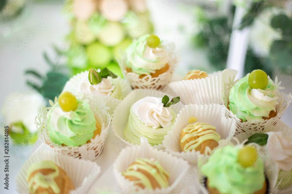 cupcakes with cream and grapes in paper packaging