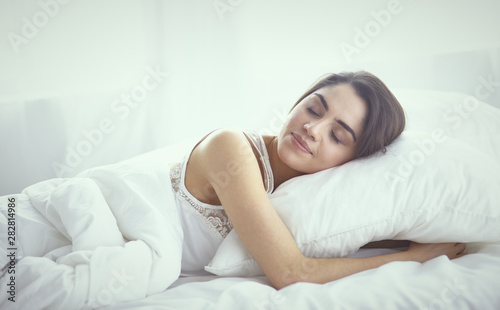 beautiful young woman basking in bed in the morning. Beautiful