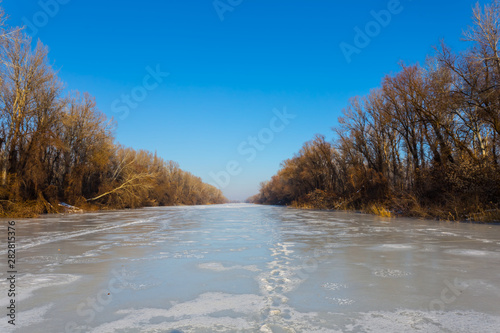 frozen river landscape at the bright cold winter day