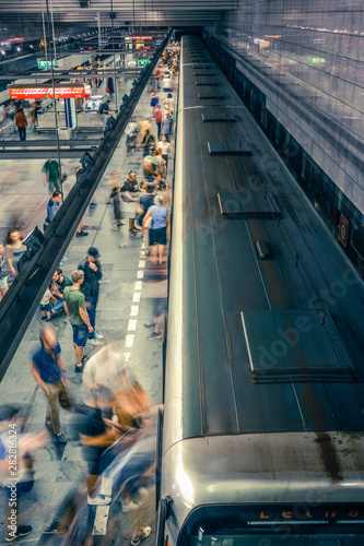 Sticker Prague, Czech Republic,23 July 2019; People at metro station entering subway train or walking by, long exposure technique for movement