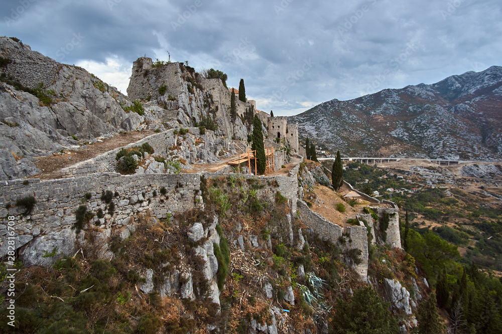 Stone walls of the medieval fortress Klis in Croatia.