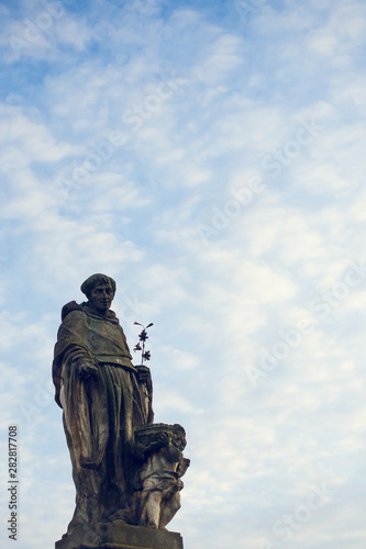 St. Nicholas of Tolentino statue on Charles Bridge in Prague, Czech Republic. Medieval Gothic bridge, finished in the 15th century, crossing the Vltava River