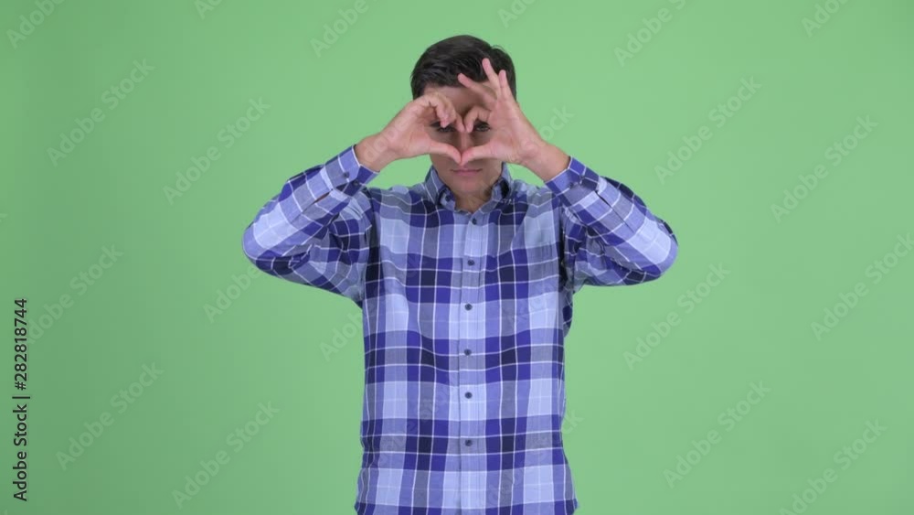 Happy young handsome hipster man with hand heart gesture Happy young handsome hipster man with hand heart gesture