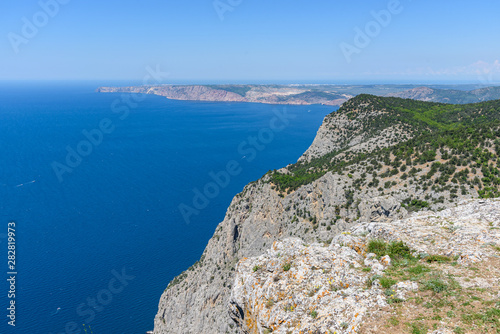 view of the Black Sea from the height of Mount Ayia  a cape on the southern coast of the Crimea  to the south-east of Balaclava. Sunny bright day with clouds on the sky. Spring view of the Crimea.
