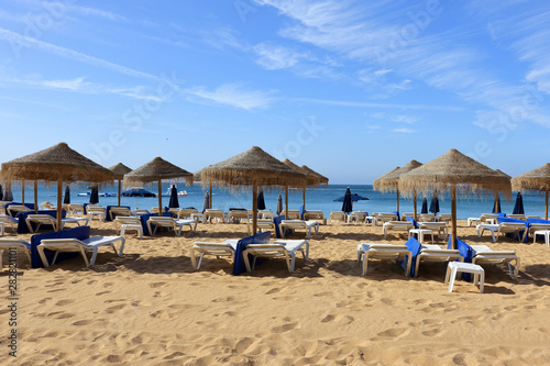 Straw umbrellas and deck chairs on the beach at Albufeira © kevinr4