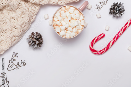 Christmas composition with cocoa, marshmallows, knitted sweater and other