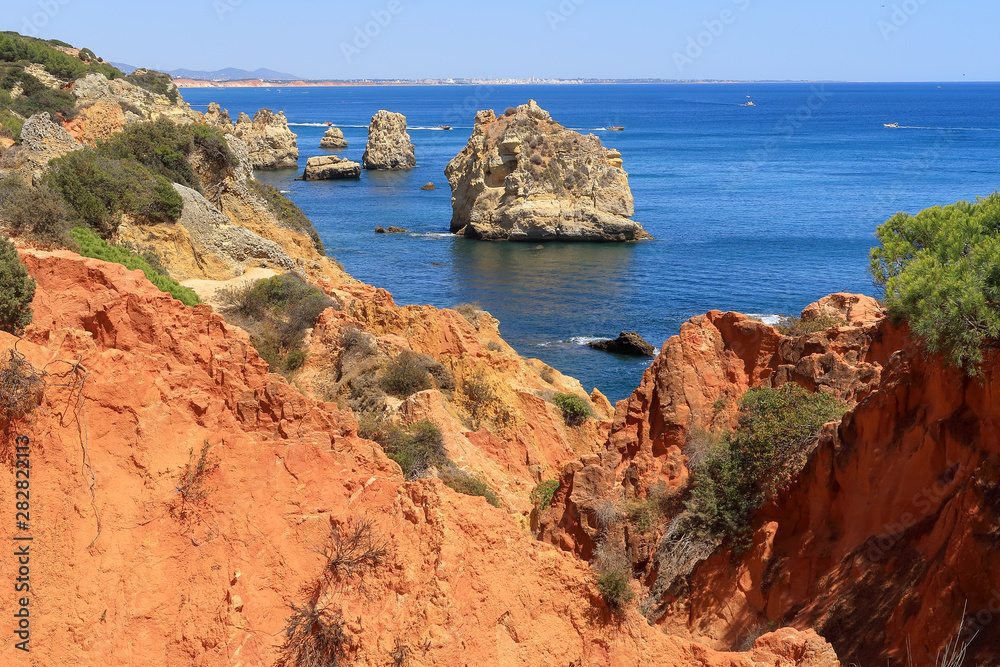 The red rocky and jagged coastline overlooking the Atlantic Ocean near Albufeira