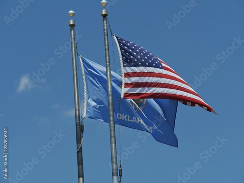 Medium close up of the flags of the United States of America and Oklahoma State photo