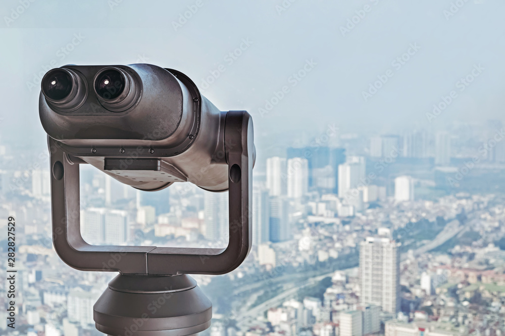 Tourist binocular close-up on the observation desk in a big megapolis city