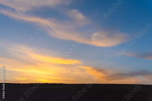 Farmland  hill with blue sky background in dusk. Silhouette view nature landscape.