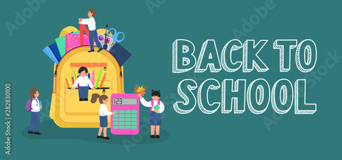 Back to school. Group of tiny primary school children on opened backpack with lettering.