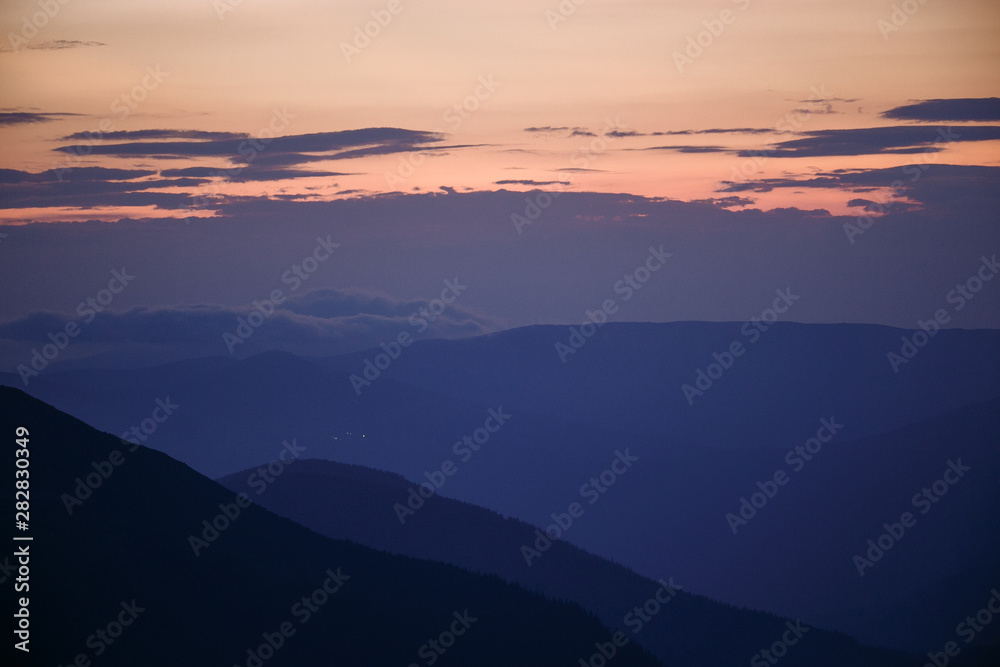 sunset in the mountains line of blue beautiful mountains