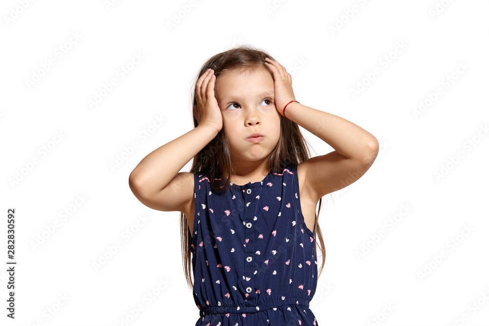 Close-up studio shot of beautiful brunette little girl posing isolated on white studio background. Close-up studio shot of beautiful brunette little girl posing isolated on white studio background.