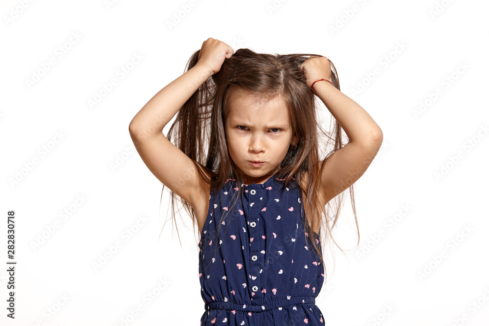 Close-up studio shot of beautiful brunette little girl posing isolated on white studio background. Close-up studio shot of beautiful brunette little girl posing isolated on white studio background.
