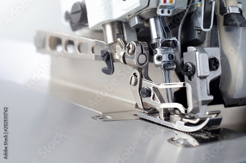 Vászonkép Mechanism of an industrial overlock sewing machine - closeup view on foot and ne