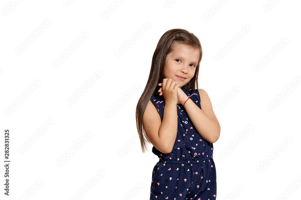 Close-up studio shot of beautiful brunette little girl posing isolated on white studio background. Close-up studio shot of beautiful brunette little girl posing isolated on white studio background.