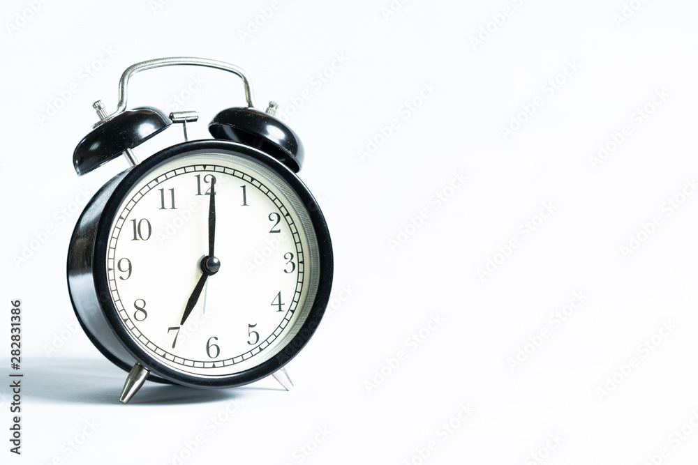 Black alarm clock isolated on white Black alarm clock isolated on white