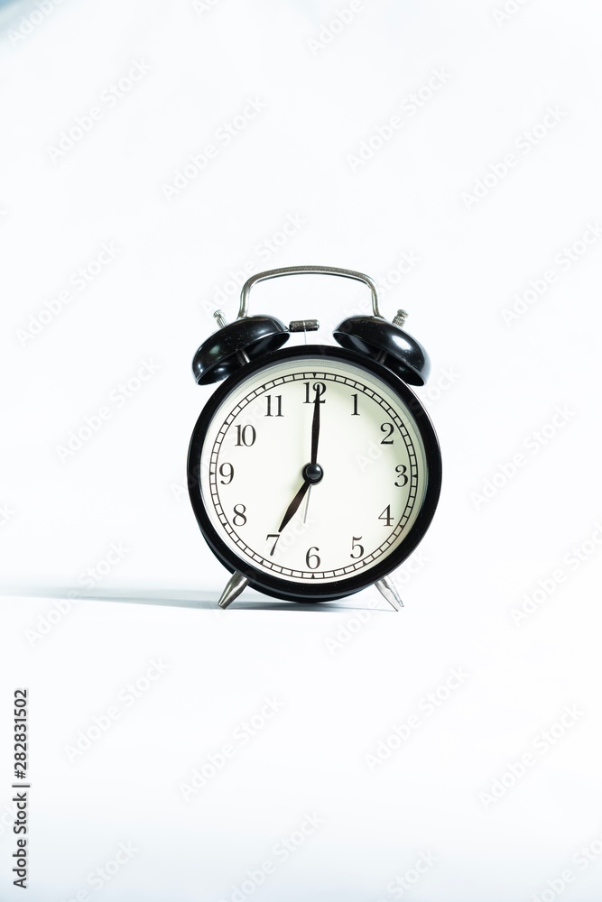 Black alarm clock isolated on white Black alarm clock isolated on white
