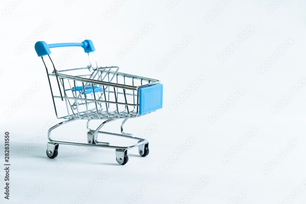 Mini shopping trolley isolated against white background Mini shopping trolley isolated against white background