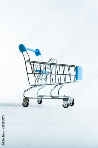 Mini shopping trolley isolated against white background