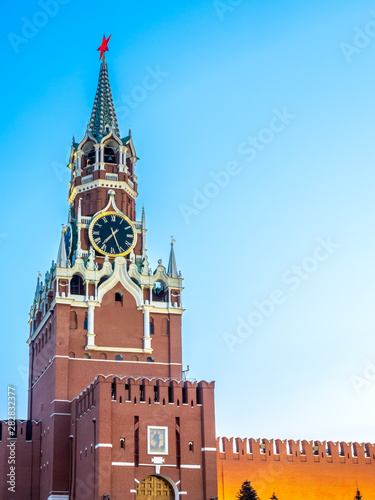 Spasskaya tower, clock tower exit to Red Square, wall of Kremlin under twilight evening sky, Moscow, Russia
