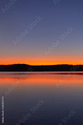 Lake sunset silhouette. Finnish lake landscape photo.
