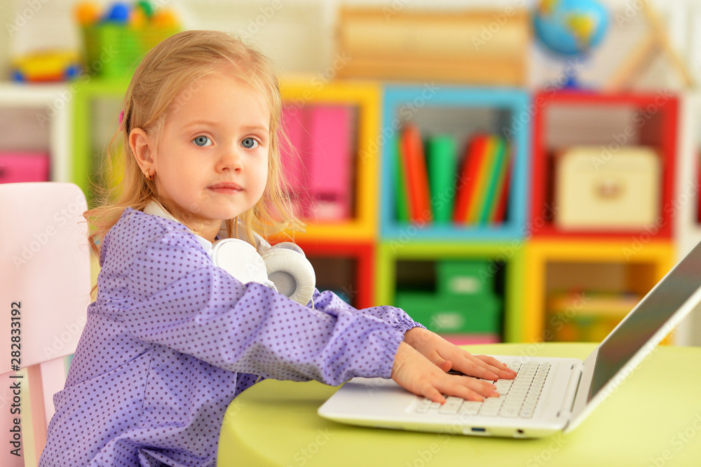Portrait of emotional cute girl using laptop at home Portrait of emotional cute girl using laptop at home