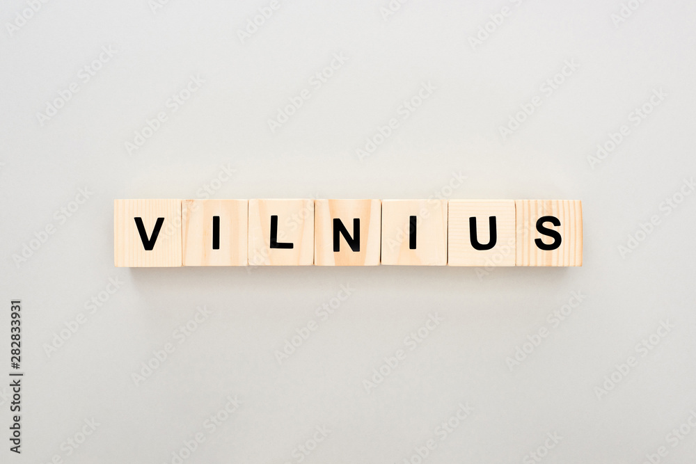 top view of wooden blocks with Vilnius lettering on white background top view of wooden blocks with Vilnius lettering on white background