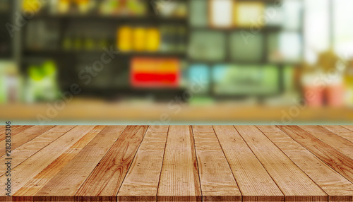 Empty wooden table with abstract blurred background of coffee shop