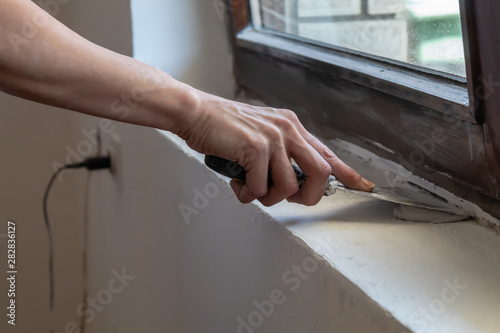 Woman Hand Working With Spatula Below Wooden Window