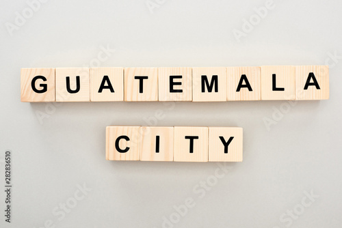 top view of wooden blocks with Guatemala city lettering on grey background