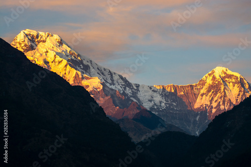 Rock mountain peaks in Annapurna mountain range with light of sunrise, Nepal